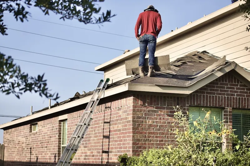 Professional roofer working on a residential roof in Dillonvale